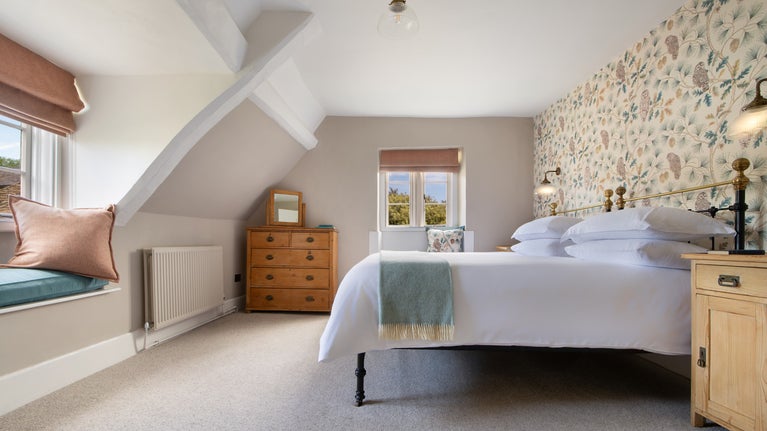 The super king-size bedroom at 20 Church Street, with window seats, Wiltshire
